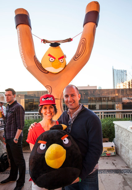 Picture of people posing in front of the Angry Birds slingshot sculpture.