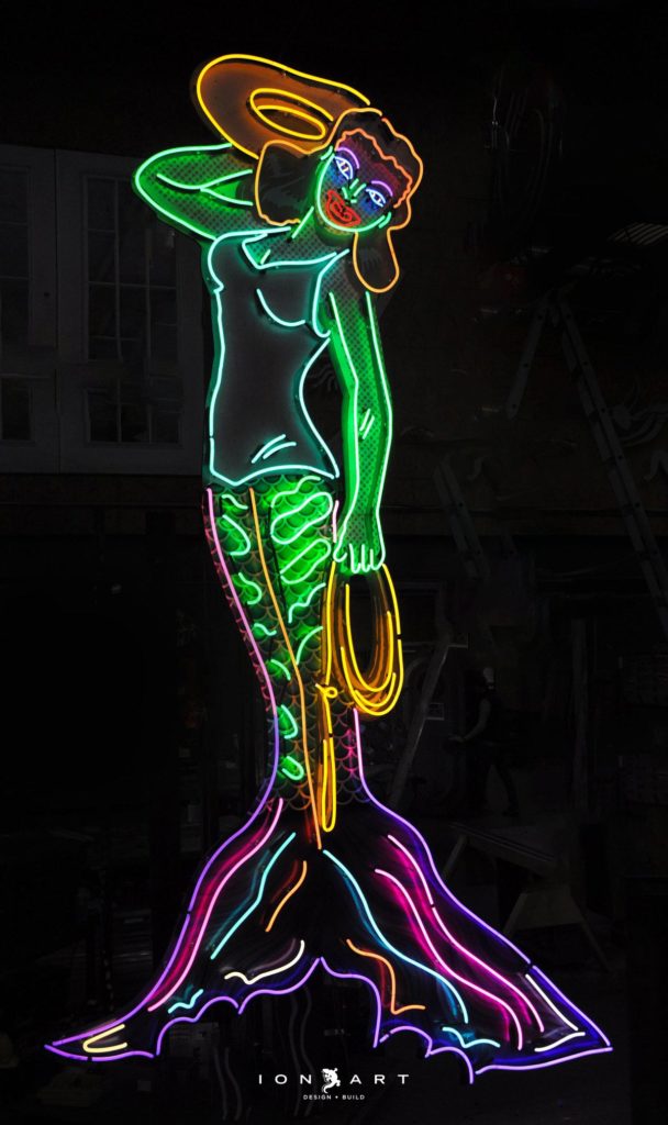 Picture of a neon mermaid.