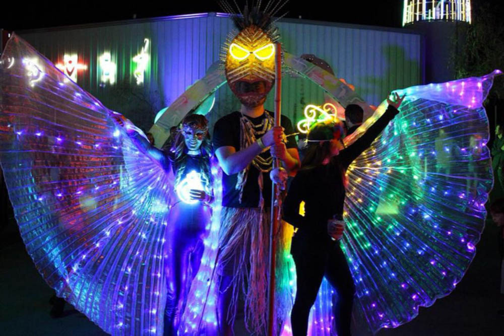 Picture of attendees wearing LED festival wings.