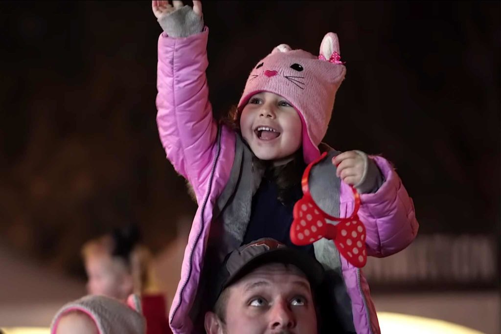 Picture of a child enjoying the Trail of Lights festival.