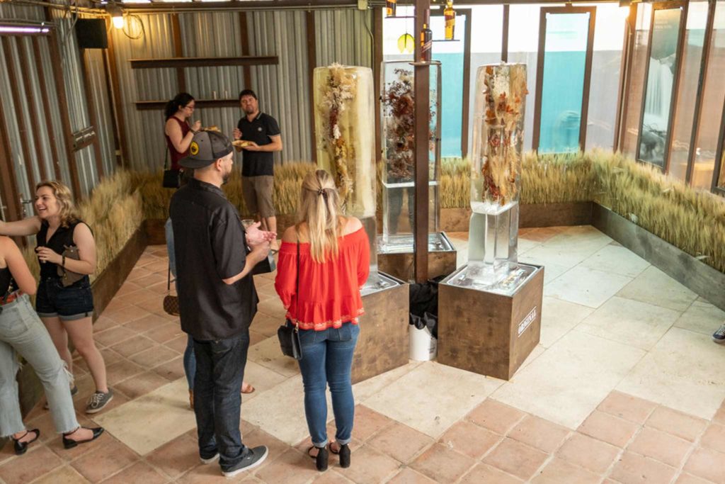 Picture of event attendees in a lobby filled with barley.
