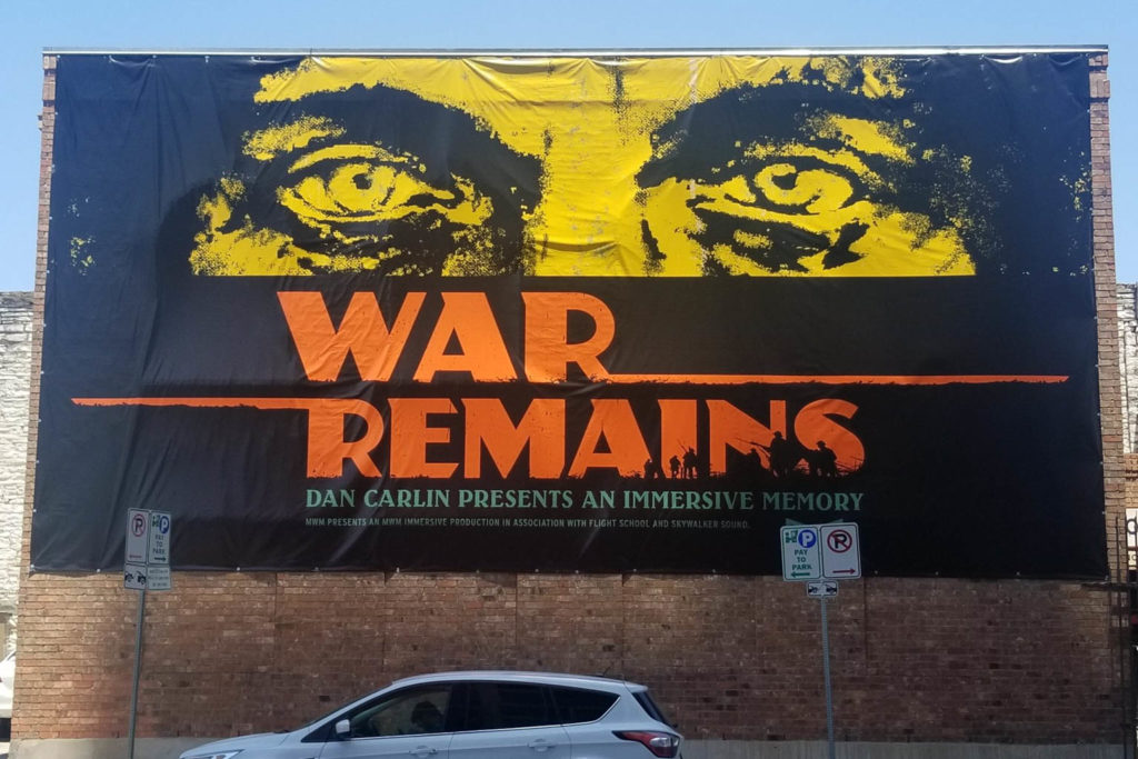 Picture of War Remains banner hanging on the venue building on 5th street, downtown Austin.