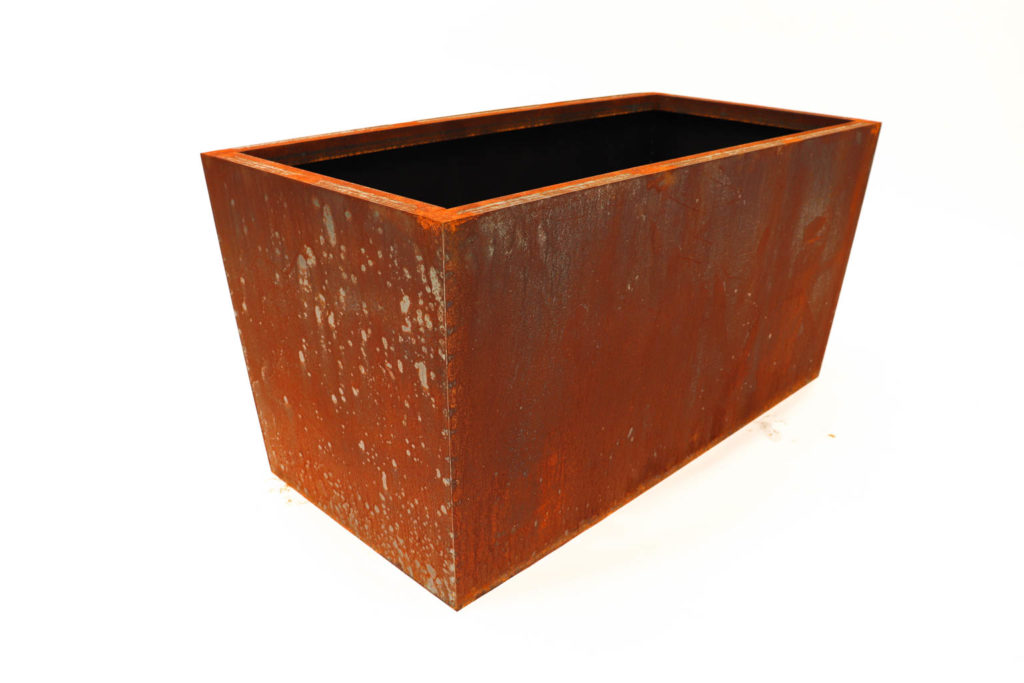 Picture of a rustic steel rectangle planter with white backdrop.