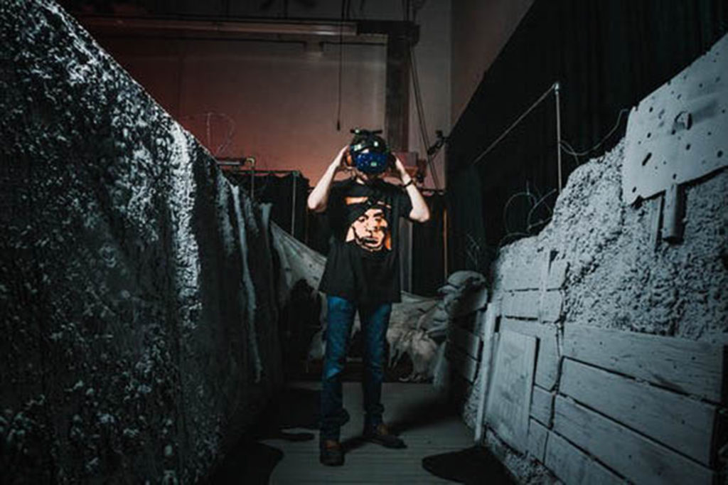Picture of a person walking through the trenches of the War Remains VR Experience.
