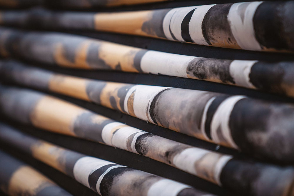 Close up picture of grayscale painted baseball bats.