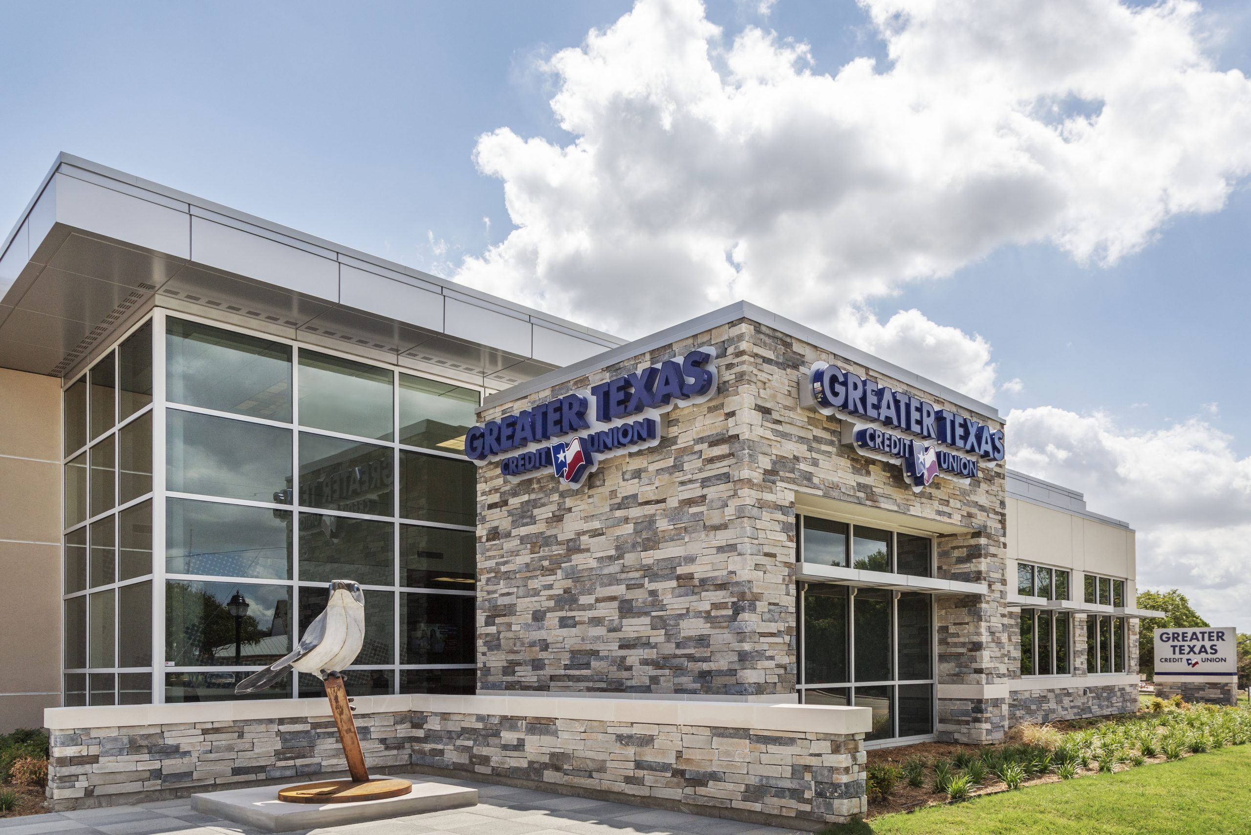 Picture of Greater Texas Credit Union and the steel sculpture.